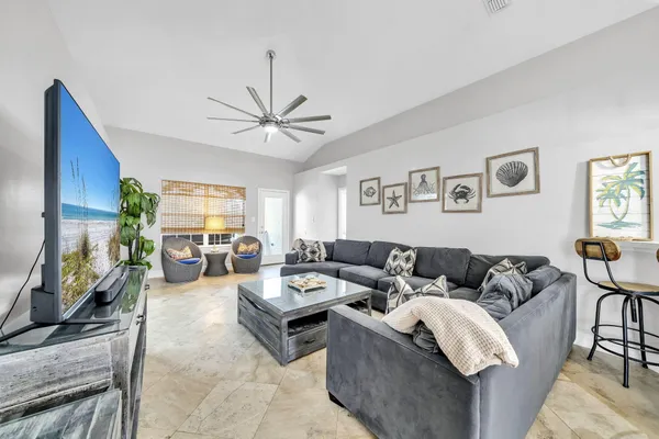 a living room with furniture flat screen tv and a fireplace