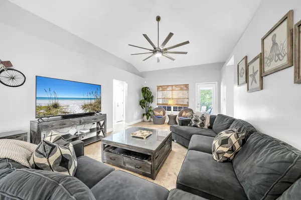 a living room with furniture flat screen tv and a window
