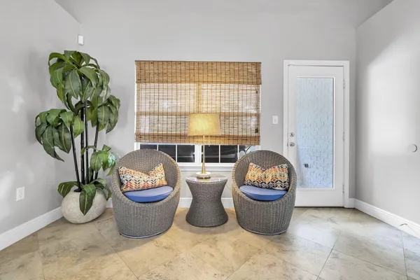 a living room with furniture and a potted plant