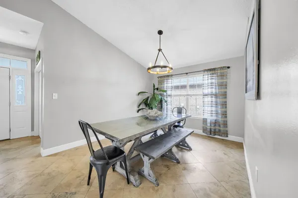 a dining room with furniture and window