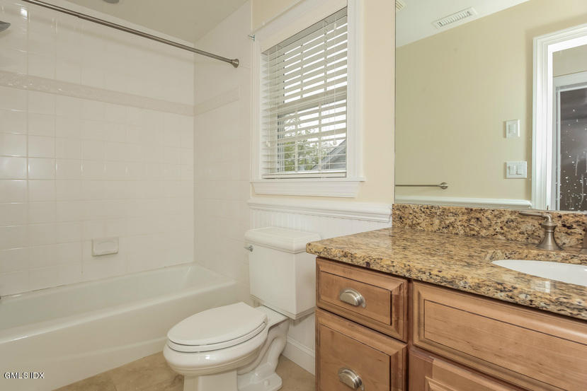 25 Decatur Street, Unit A Cos Cob, CT 06807 - Photo 21 of 29 a bathroom with a granite countertop sink toilet and shower