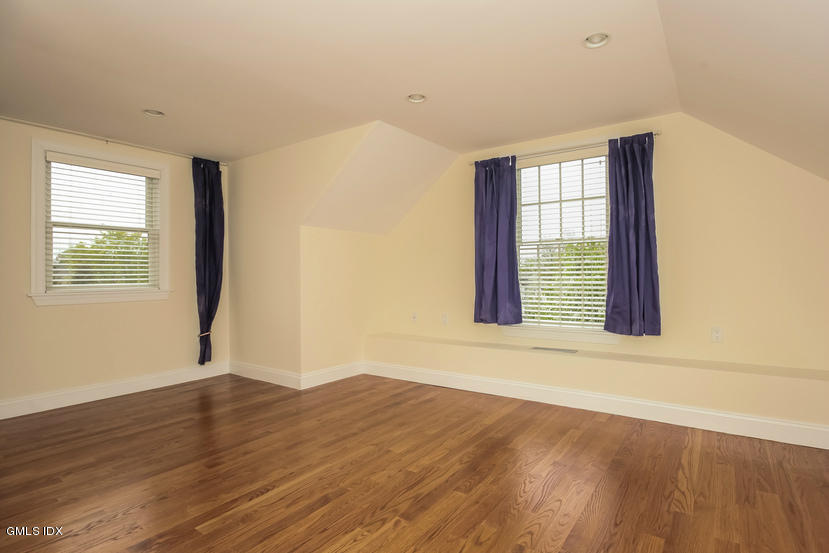 25 Decatur Street, Unit A Cos Cob, CT 06807 - Photo 22 of 29 a view of an empty room with wooden floor and a window