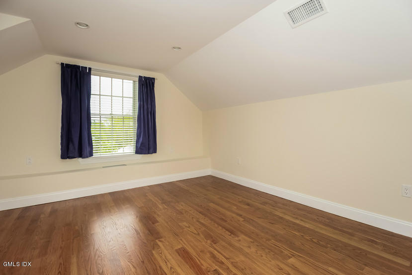 25 Decatur Street, Unit A Cos Cob, CT 06807 - Photo 24 of 29 an empty room with wooden floor and windows