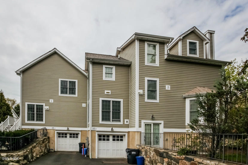 25 Decatur Street, Unit A Cos Cob, CT 06807 - Photo 28 of 29 a view of a big house with a yard and large windows