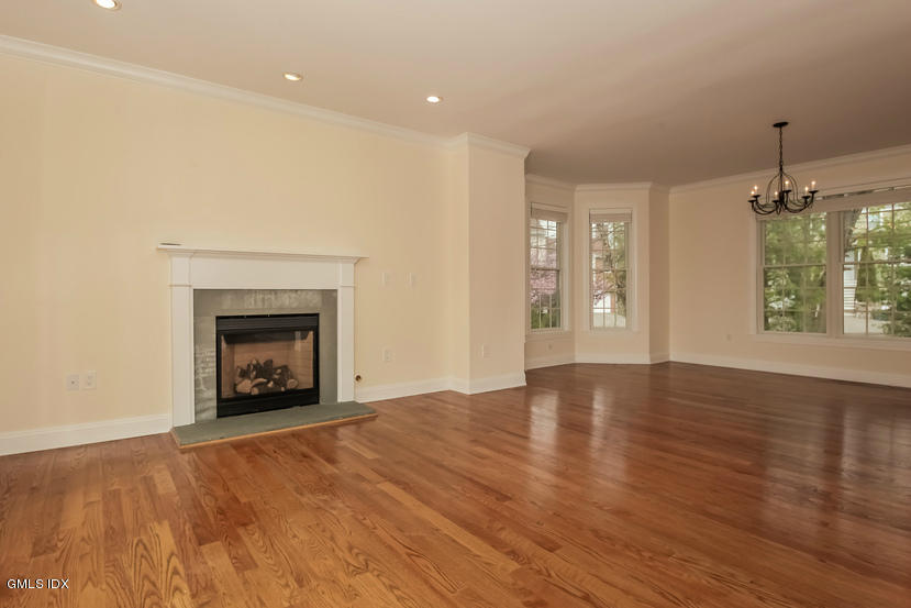 25 Decatur Street, Unit A Cos Cob, CT 06807 - Photo 7 of 29 an empty room with windows and fireplace