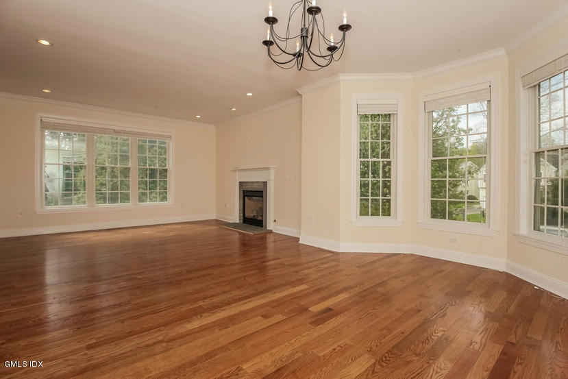25 Decatur Street, Unit A Cos Cob, CT 06807 - Photo 9 of 29 a view of an empty room with wooden floor and a window