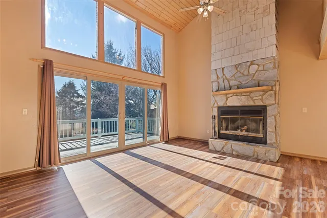 a view of a fireplace with a large window with kitchen view