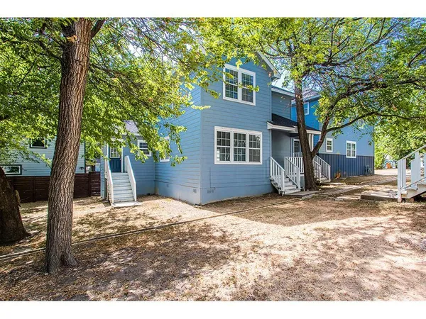 a view of a backyard with a tree