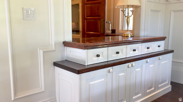 426 West Center Street Parowan, UT 84761 - Photo 12 of 107 Built-in cabinetry featuring white shaker-style doors and drawers, dark wood-finish countertops, and a polished stone upper counter
