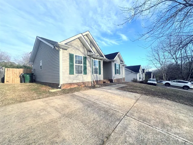 a view of a house with a yard and garage