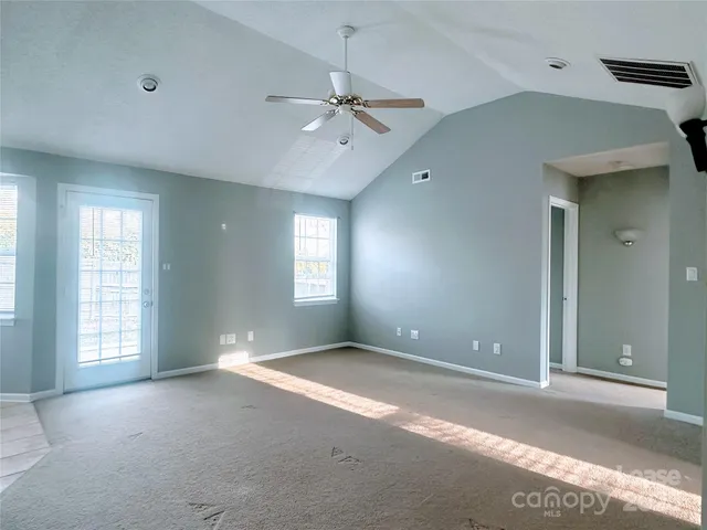 an empty room with windows and closet