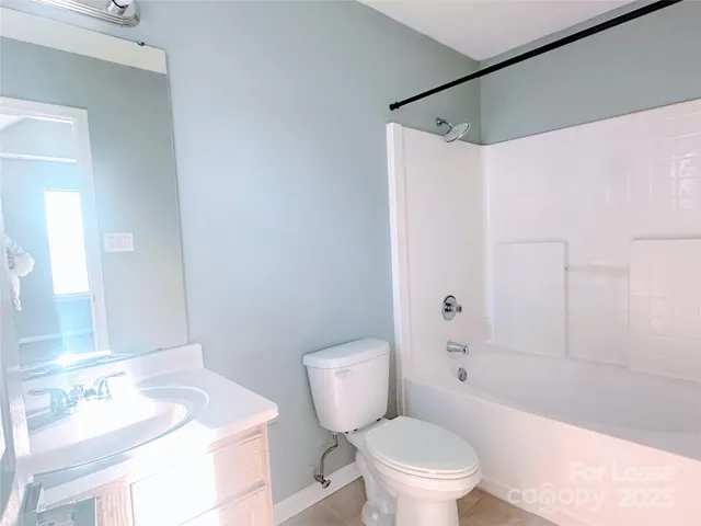 a white toilet sitting next to a bath tub