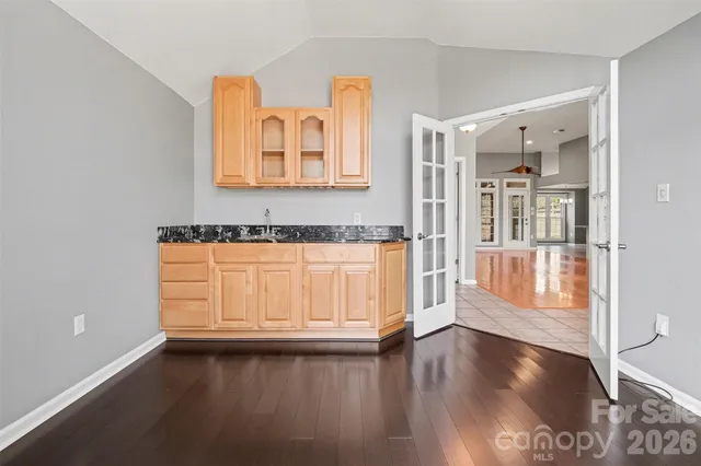 a view of a room with wooden floor and cabinet