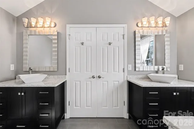 a bathroom with a sink vanity and a mirror