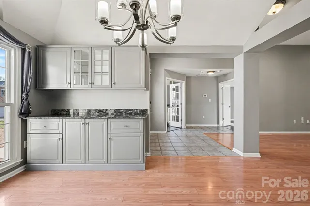 a kitchen with stainless steel appliances granite countertop a refrigerator and cabinets