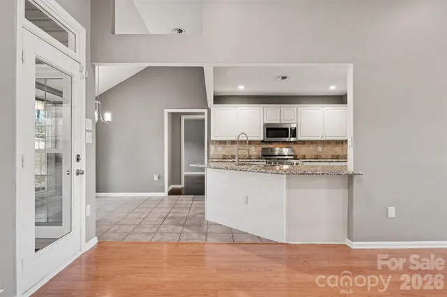 a view of kitchen with granite countertop cabinets