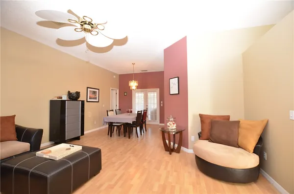a living room with furniture a dining table and a piano