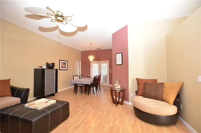 a living room with furniture a dining table and a piano