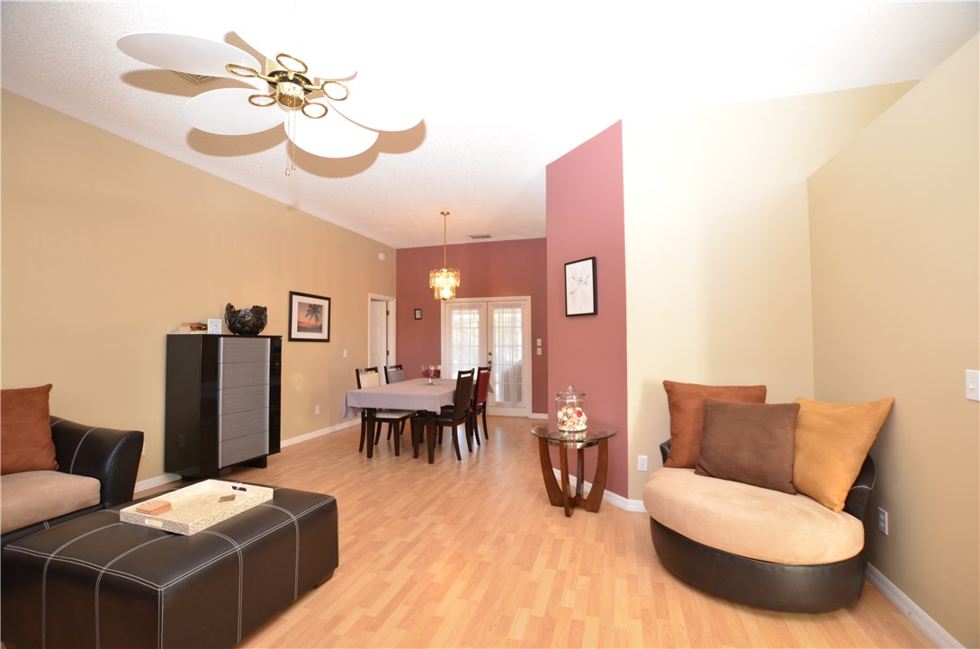 155 Midvale Terrace Sebastian, FL 32958 - Photo 3 of 16 a living room with furniture a dining table and a piano