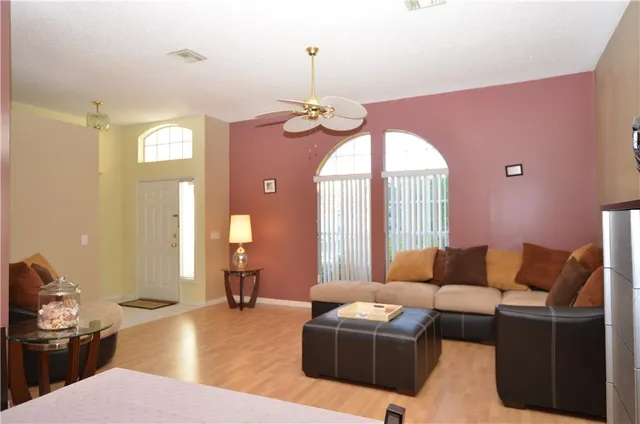 a living room with furniture a lamp and a chandelier