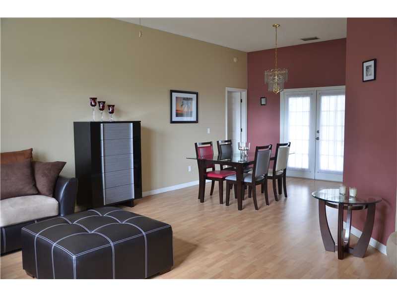 155 Midvale Terrace Sebastian, FL 32958 - Photo 5 of 16 a living room with furniture a dining table and a refrigerator