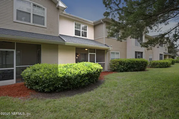 a aerial view of a house with large trees and plants