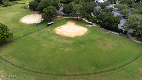an aerial view of a house with swimming pool patio and lake view