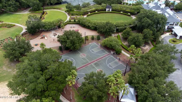 an aerial view of a house with garden space and a lake view