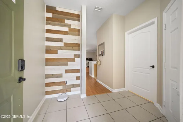 a kitchen with stainless steel appliances granite countertop a stove top oven a sink dishwasher and a refrigerator with wooden floor