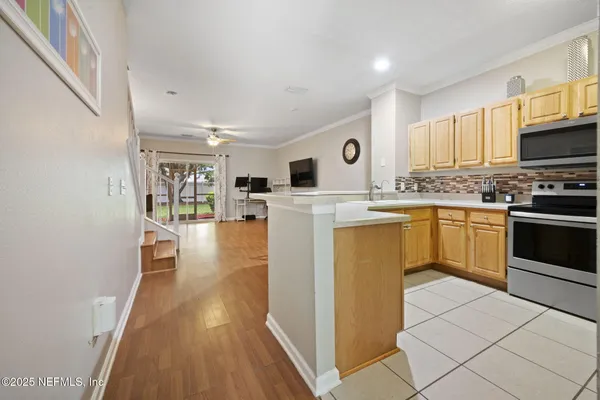 a kitchen with a stove a sink and a refrigerator
