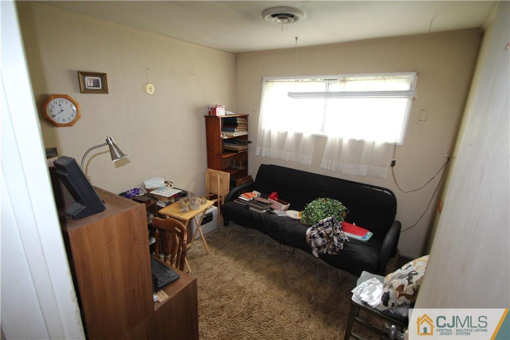 3 Vernon Road Edison, NJ 08817 - Photo 11 of 16 a living room with furniture and a fireplace