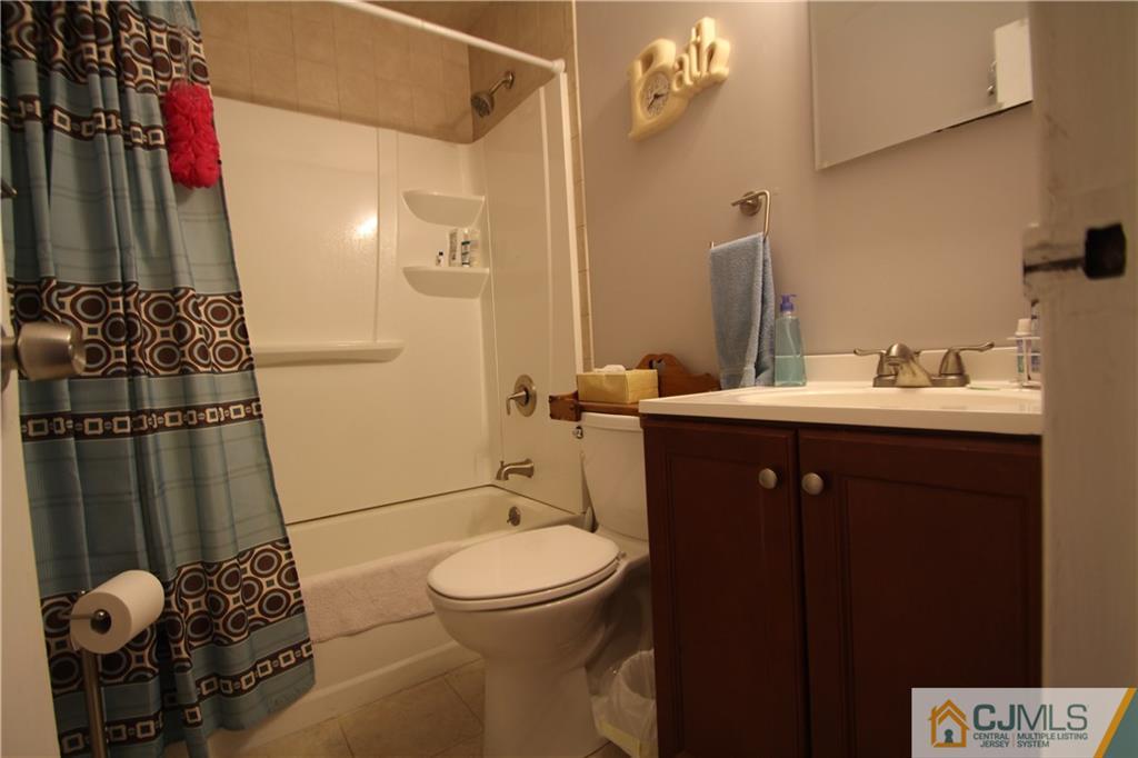 3 Vernon Road Edison, NJ 08817 - Photo 14 of 16 a bathroom with a sink a toilet and shower