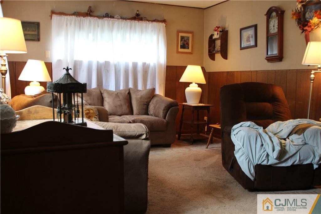 3 Vernon Road Edison, NJ 08817 - Photo 4 of 16 a living room with furniture and a fireplace