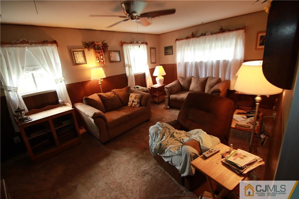 3 Vernon Road Edison, NJ 08817 - Photo 5 of 16 a living room with furniture a lamp and a window
