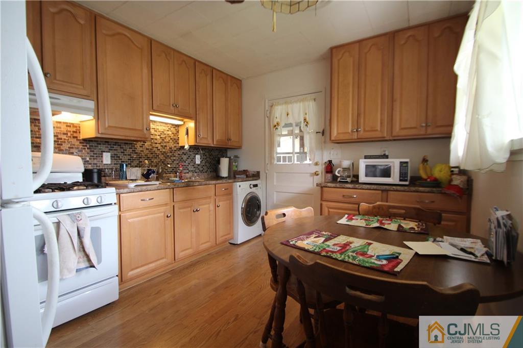 3 Vernon Road Edison, NJ 08817 - Photo 6 of 16 a kitchen with a stove a sink dishwasher and cabinets with wooden floor