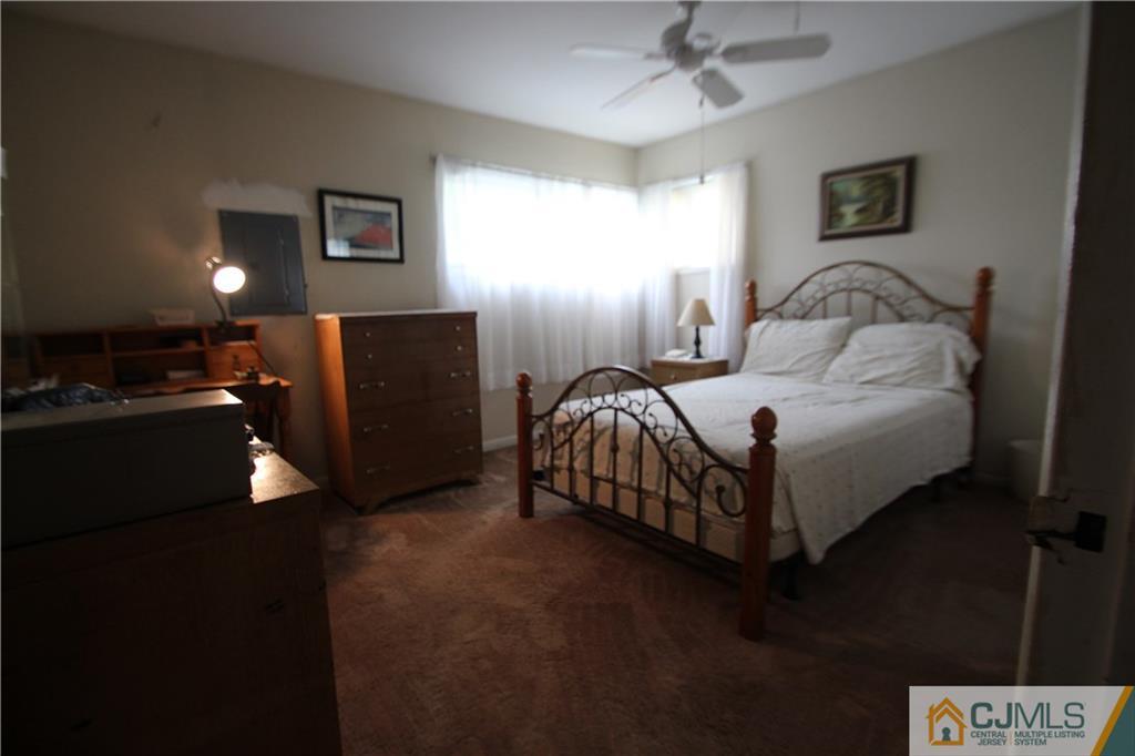 3 Vernon Road Edison, NJ 08817 - Photo 8 of 16 a bedroom with a bed and a lamp