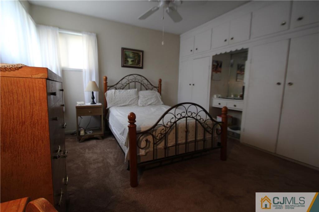 3 Vernon Road Edison, NJ 08817 - Photo 9 of 16 a bedroom with a bed and a potted plant