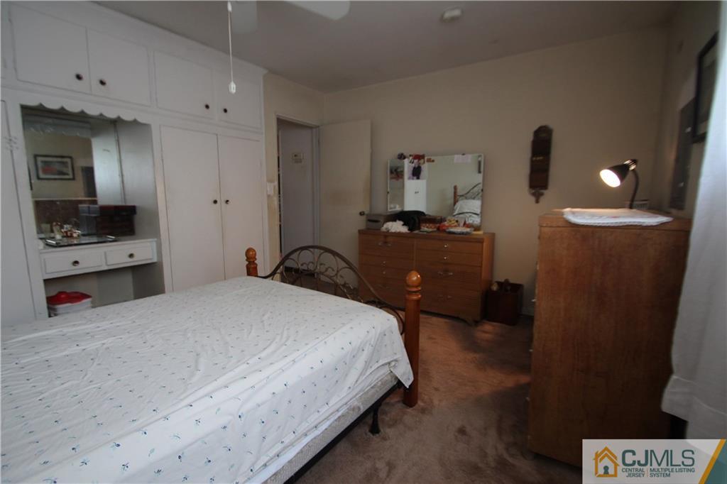 3 Vernon Road Edison, NJ 08817 - Photo 10 of 16 a bedroom with a bed and a view of kitchen
