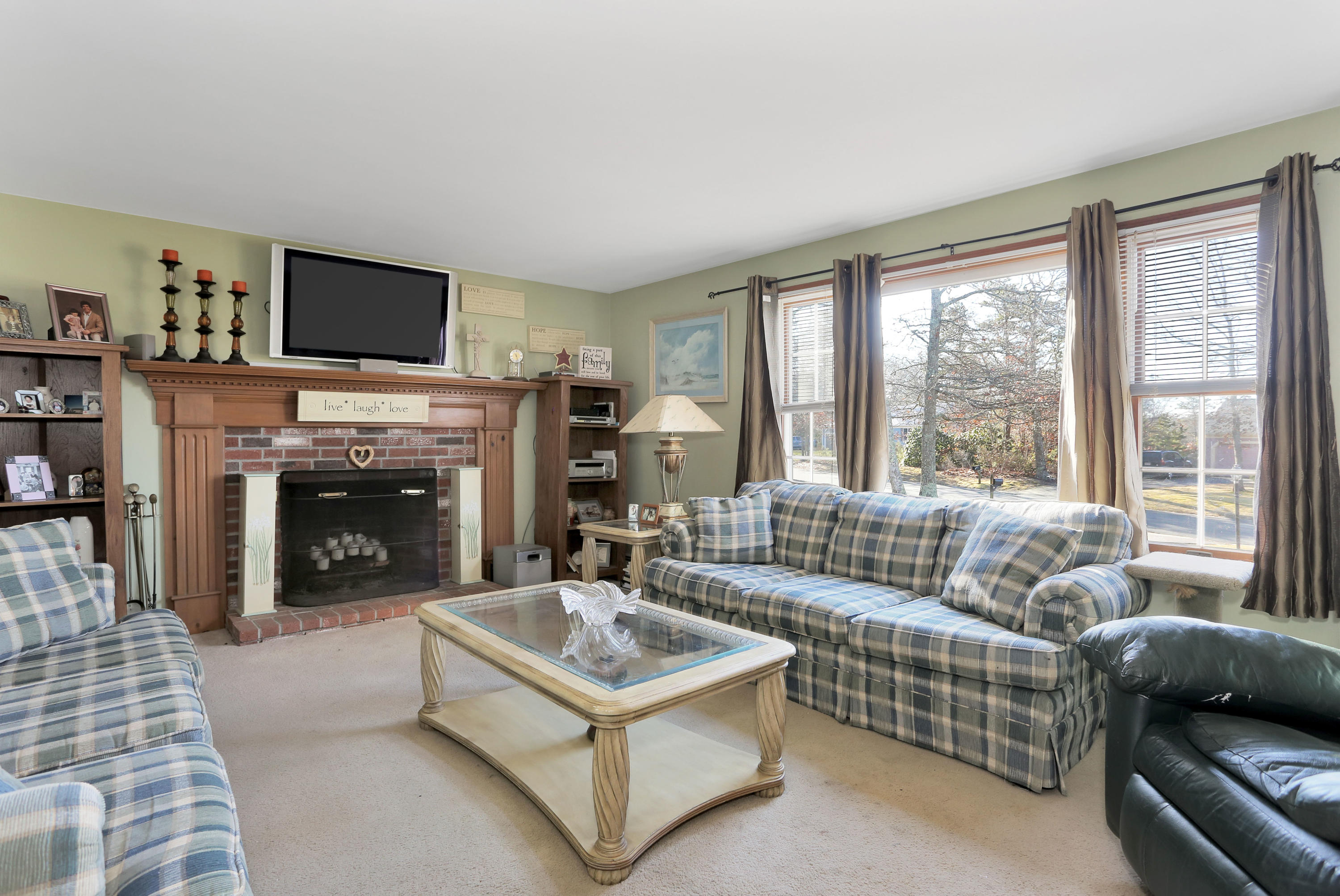 188 Camelback Road Marstons Mills, MA 02648 - Photo 3 of 22 a living room with furniture a flat screen tv and a fireplace