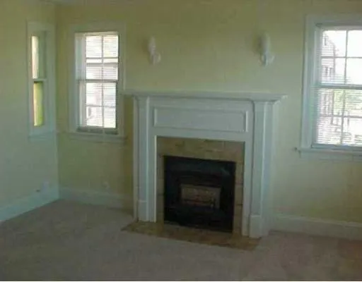 a room with a fireplace and a window
