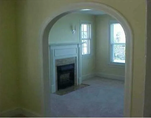 an empty room that has a fireplace in it