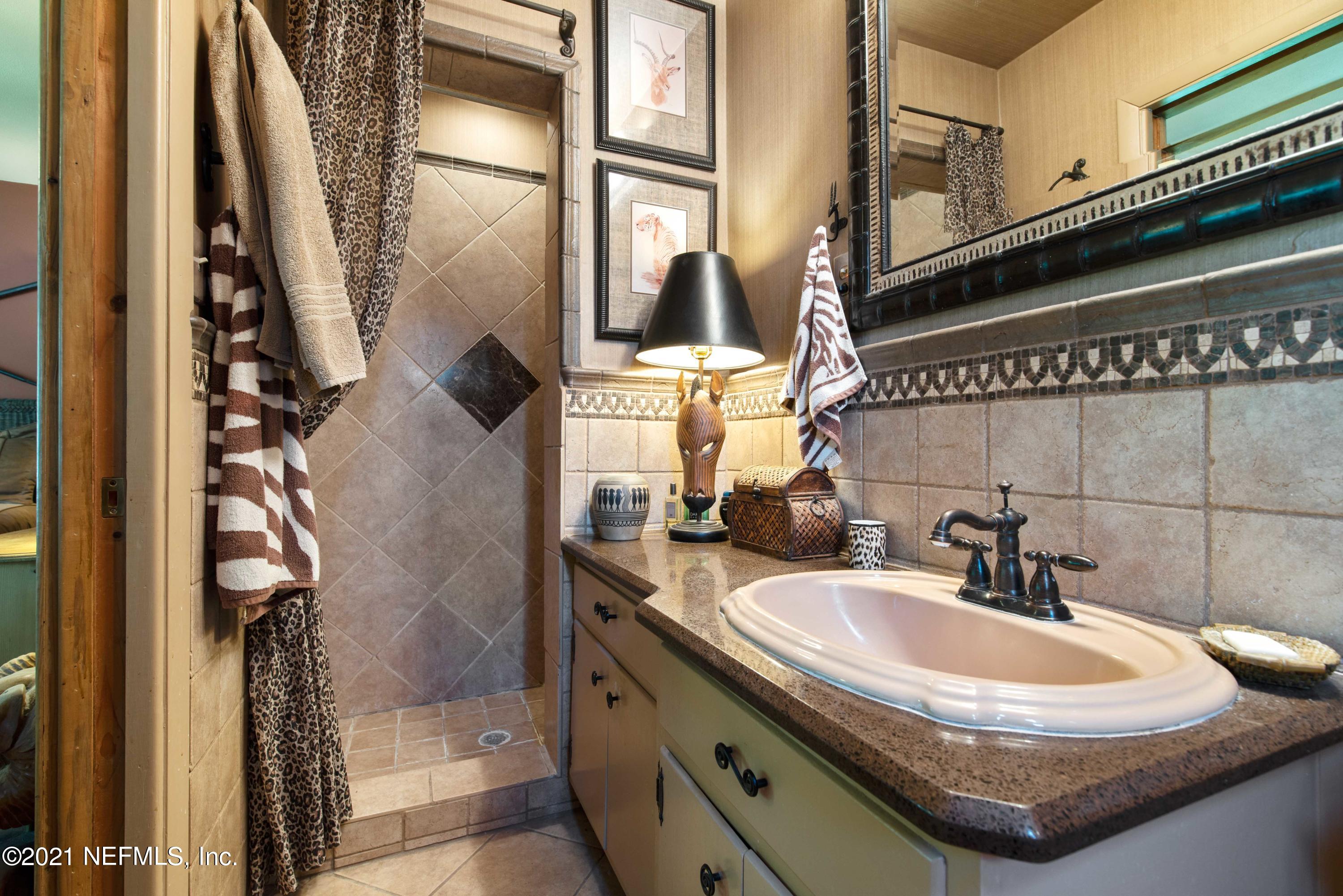 6514 Colgate Road Jacksonville, FL 32217 - Photo 17 of 31 a bathroom with a sink and a mirror