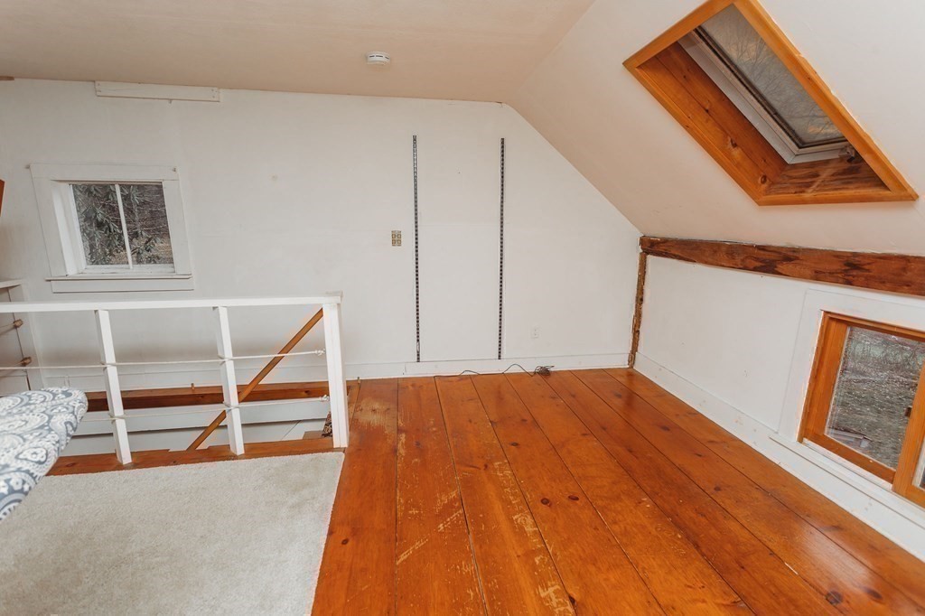 269 Ashfield Road Conway, MA 01341 - Photo 18 of 25 a view of an empty room with wooden floor and a window