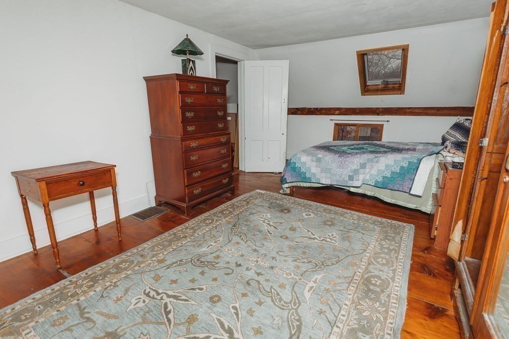269 Ashfield Road Conway, MA 01341 - Photo 19 of 25 a bedroom with a bed and wooden floor