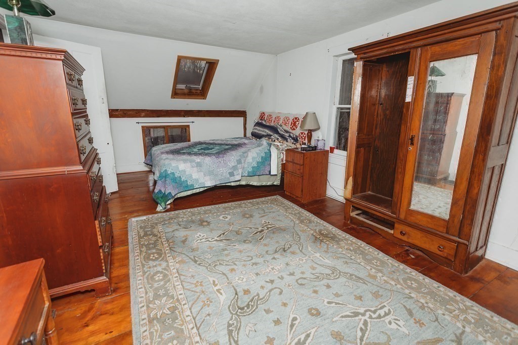 269 Ashfield Road Conway, MA 01341 - Photo 21 of 25 a bedroom with a bed and wooden floor