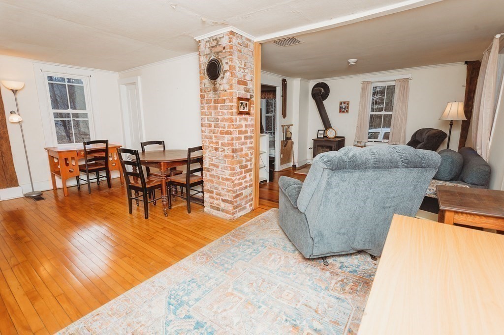 269 Ashfield Road Conway, MA 01341 - Photo 4 of 25 a living room with furniture and a dining table with wooden floor