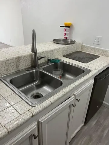 a kitchen with a sink and a stove