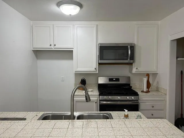 a kitchen with a stove and a microwave