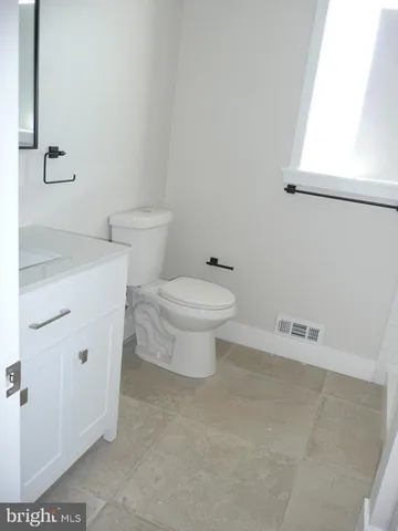 a white toilet sitting next to a bathroom sink