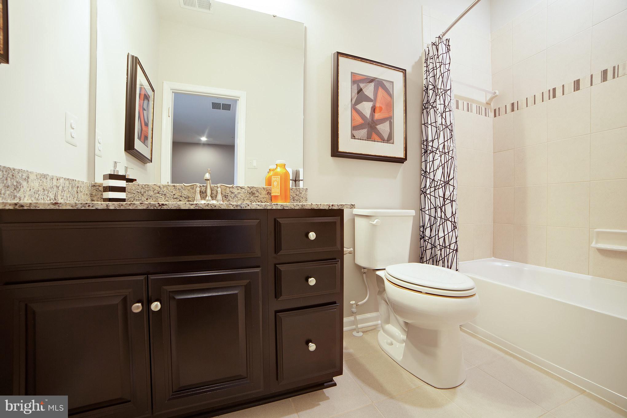 8295 Kippis Road Millersville, MD 21108 - Photo 23 of 28 a bathroom with a sink a toilet and a mirror
